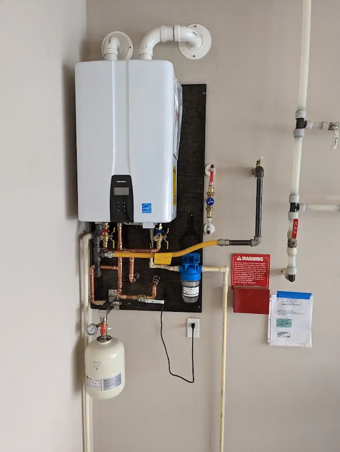 Professional plumber installing copper piping in a Wilkesboro home